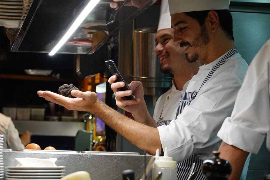 Chefs at Bar Cañete in Barcelona photographing a truffle