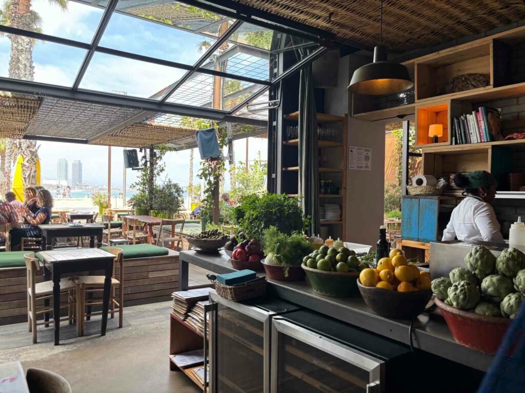 The interior of Gallito Restaurant in Barcelona with the beach in the background