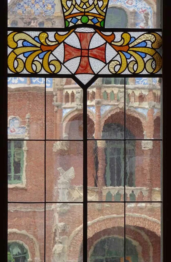 Stained glass window with the Saint George cross at the Sant Pau Art Nouveau Site