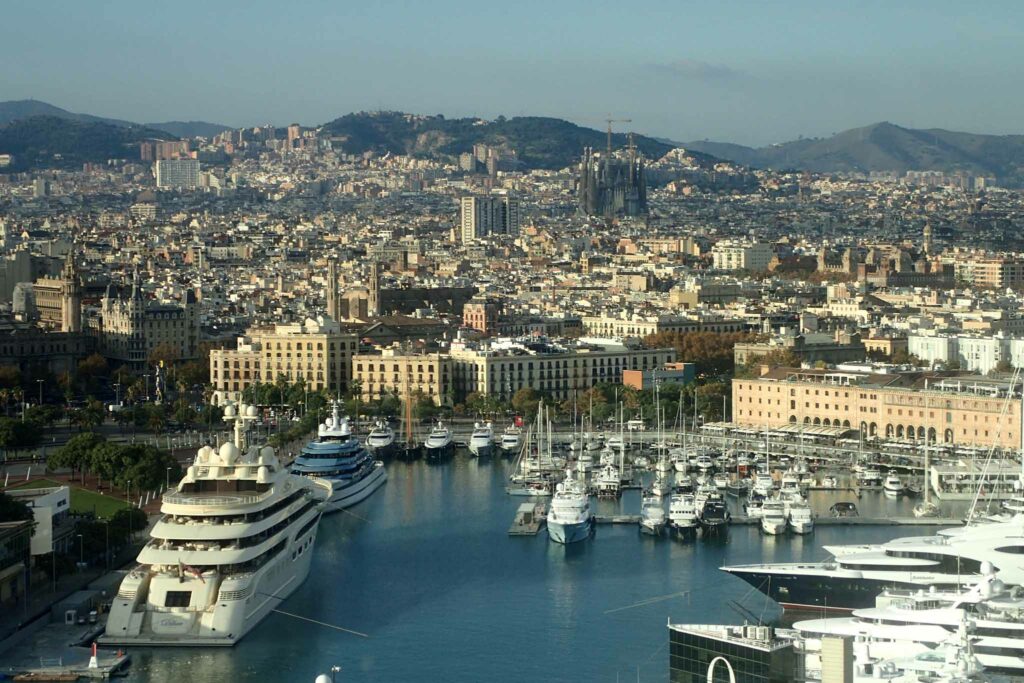 View of Barcelona over Port Vell with Sagrada Familia in the background and yachts in the foreground