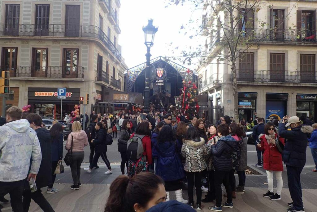 Crowds of tourists outside the entrance to La Boqueria market in Barcelona