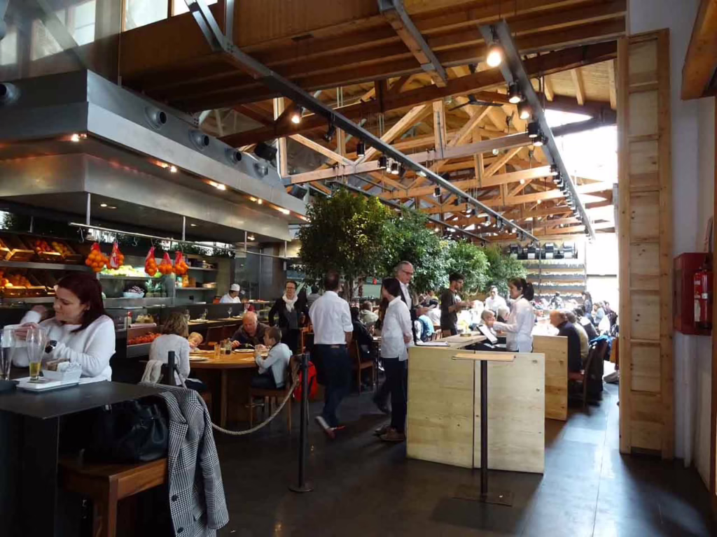Entrance to a large, open restaurant with high ceilings and beams 